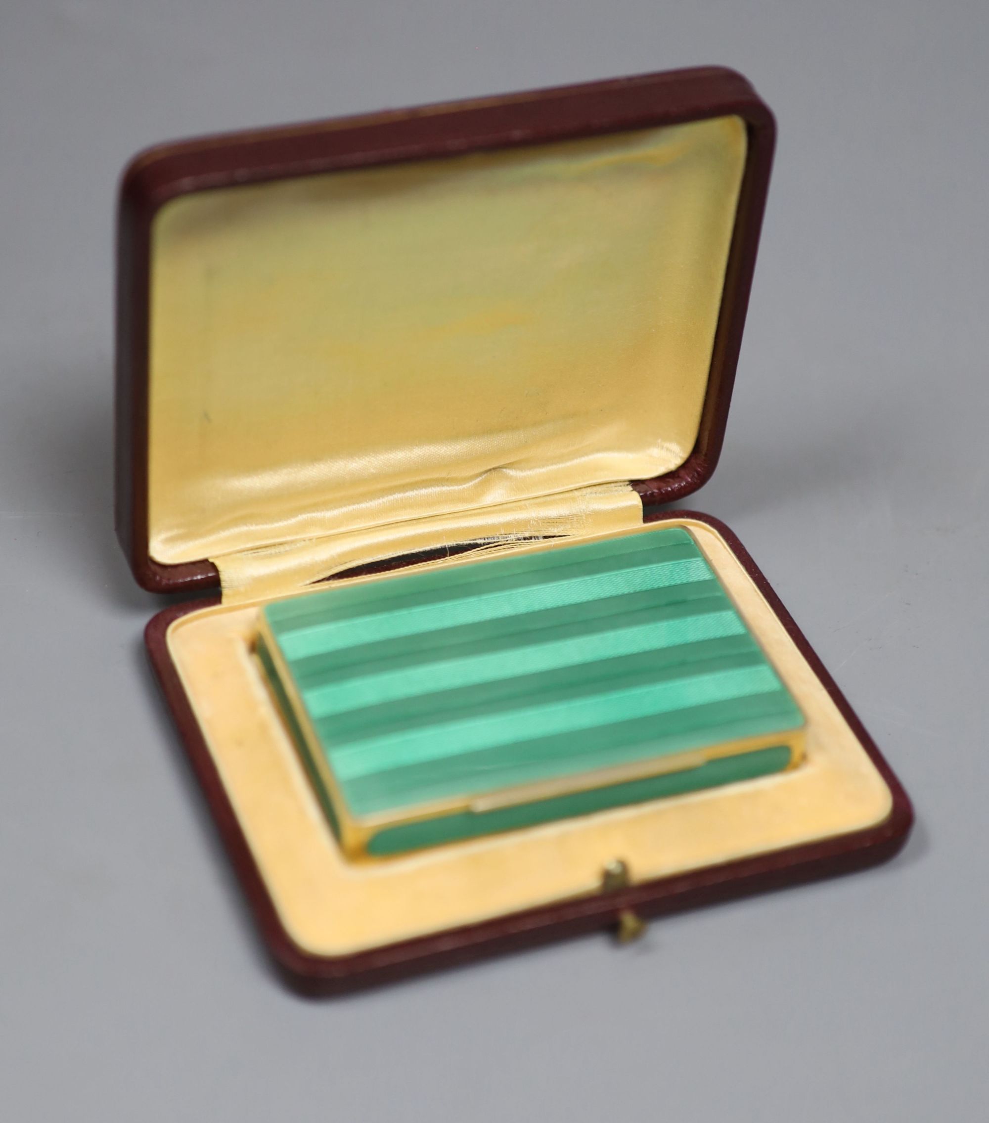 A cased early 20th century Austrian? gilt sterling and green enamelled silver gilt rectangular snuff box, 80mm, gross 122 grams,